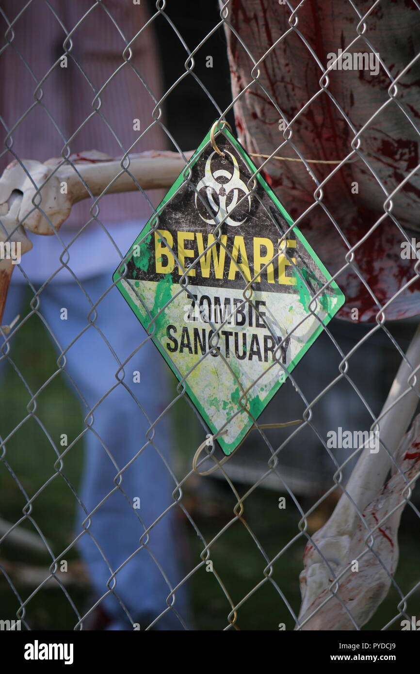 Beware Zombie Sanctuary Sign On A Chain Link Fence As Creative