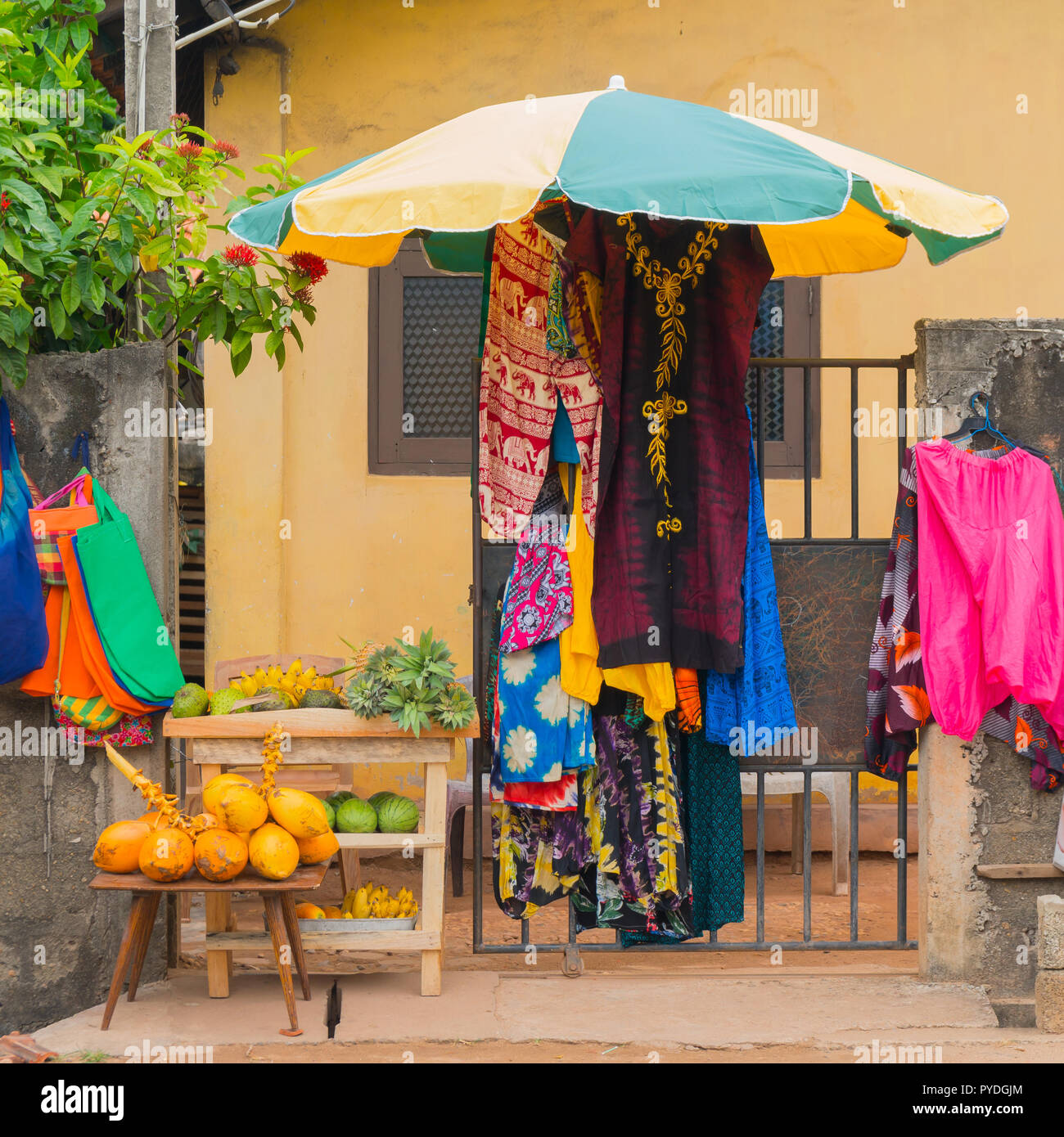 Sale of clothes and fruits on the street. Stock Photo