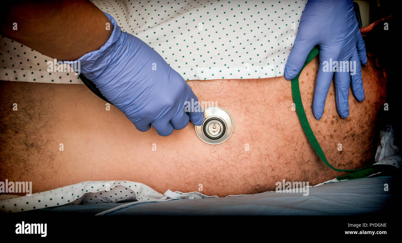 doctor auscultating young patient with the stethoscope Stock Photo