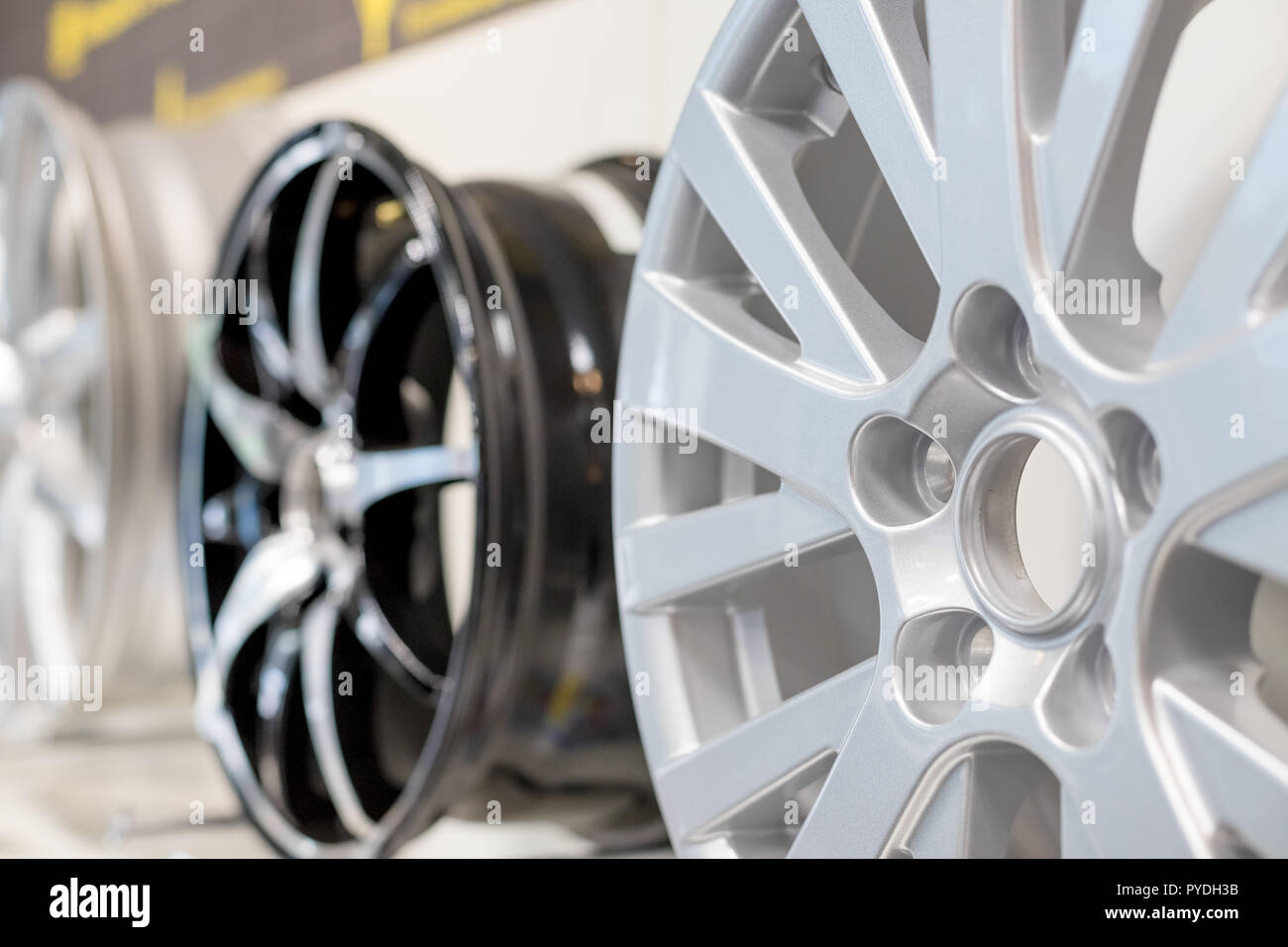 Car max wheel. Magnesium alloy wheel.Various alloy wheels in store, selective focus.car rims isolated.car rims isolated on shelf in a shop. Motor Show promotion or car workshop booklet or flyer design Stock Photo