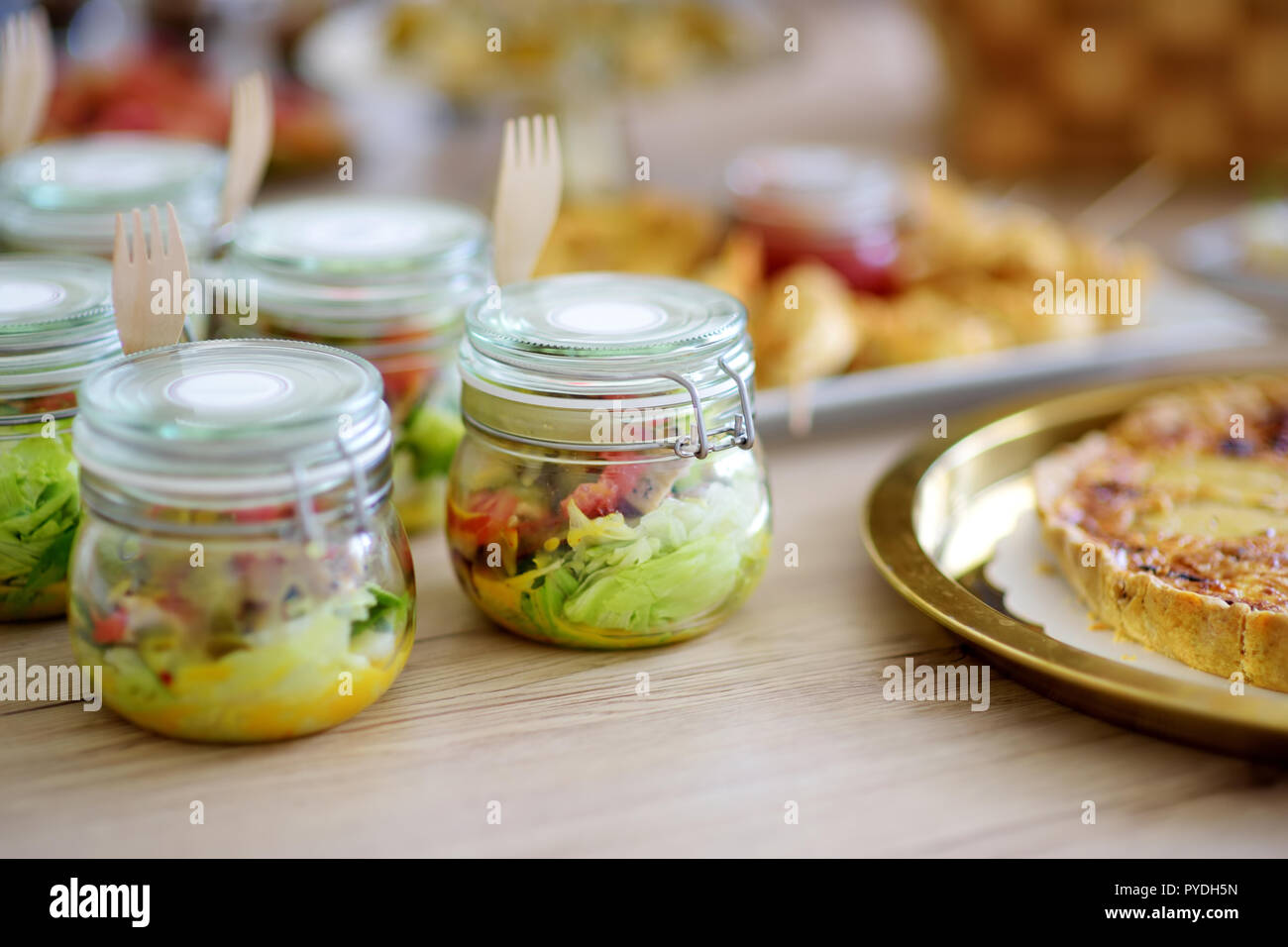 Fresh and delicious vegetable salad served in mini jars on a party or ...