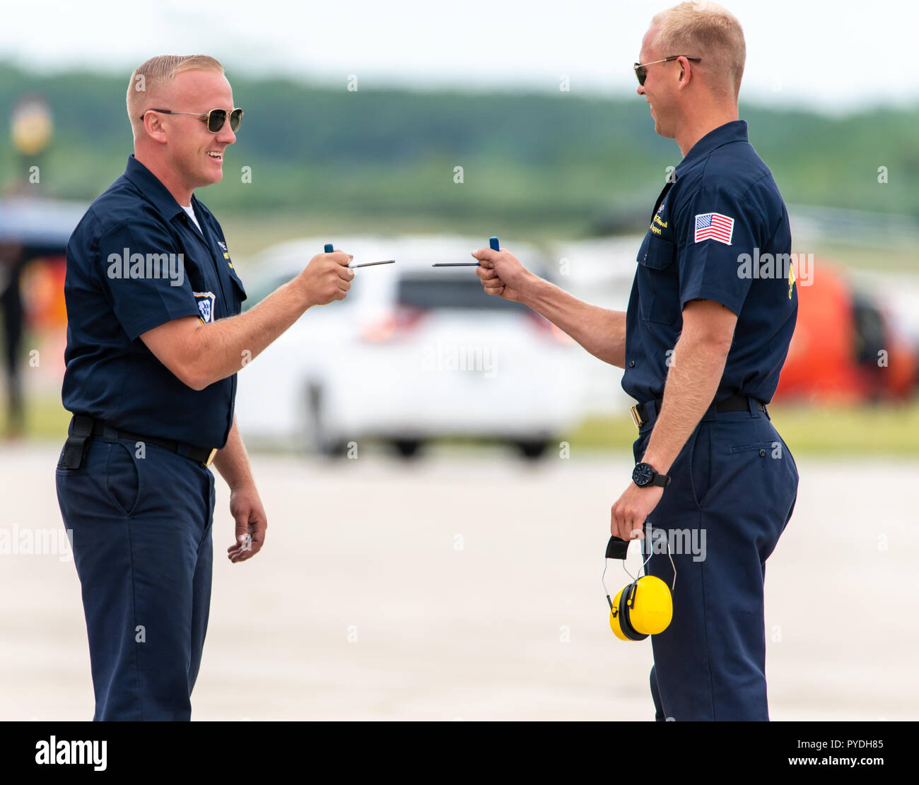 Two men on the Navy Blue Angels' ground crew joking around at the airshow. Stock Photo