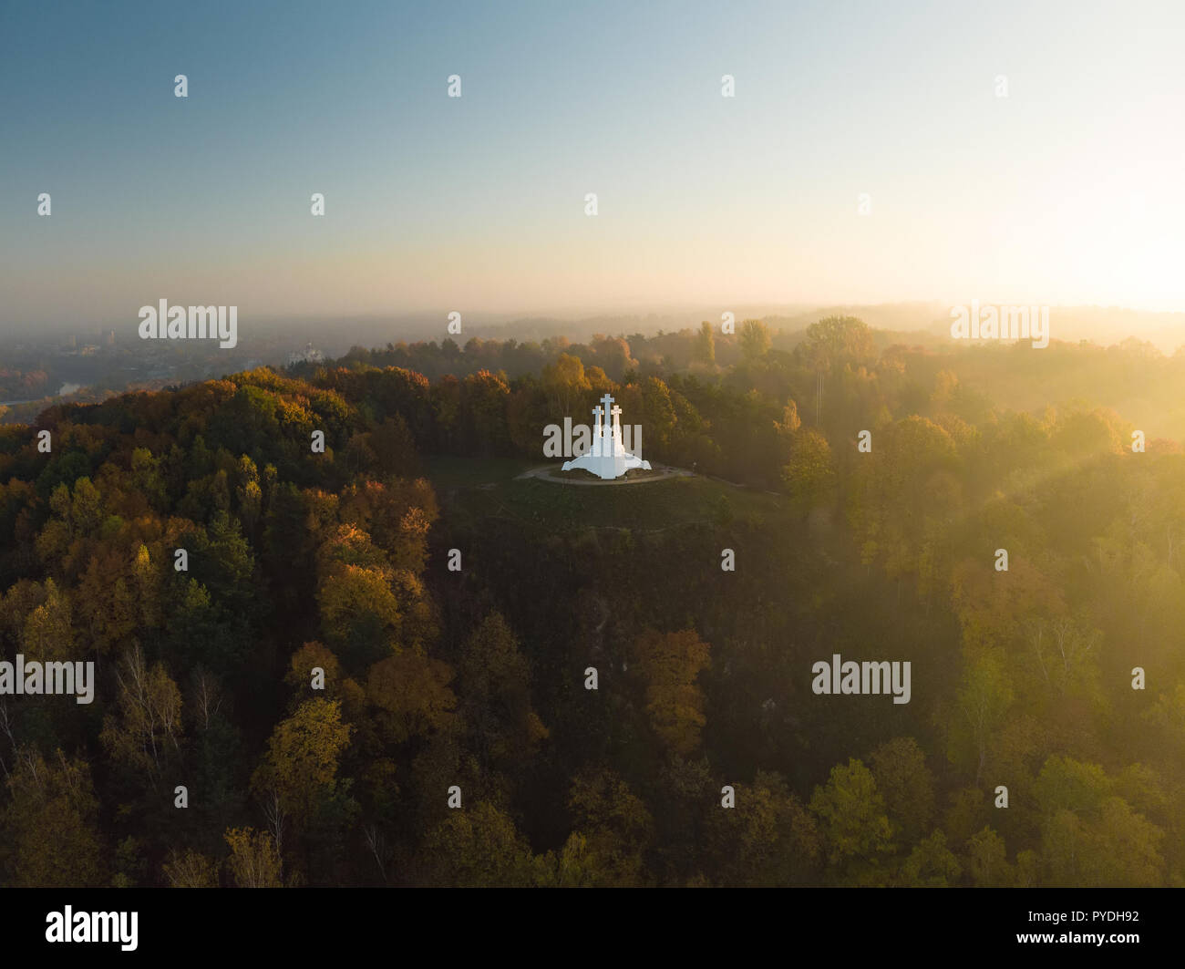 Aerial view of the Three Crosses monument overlooking Vilnius Old Town on sunset. Vilnius landscape from the Hill of Three Crosses, located in Kalnai  Stock Photo