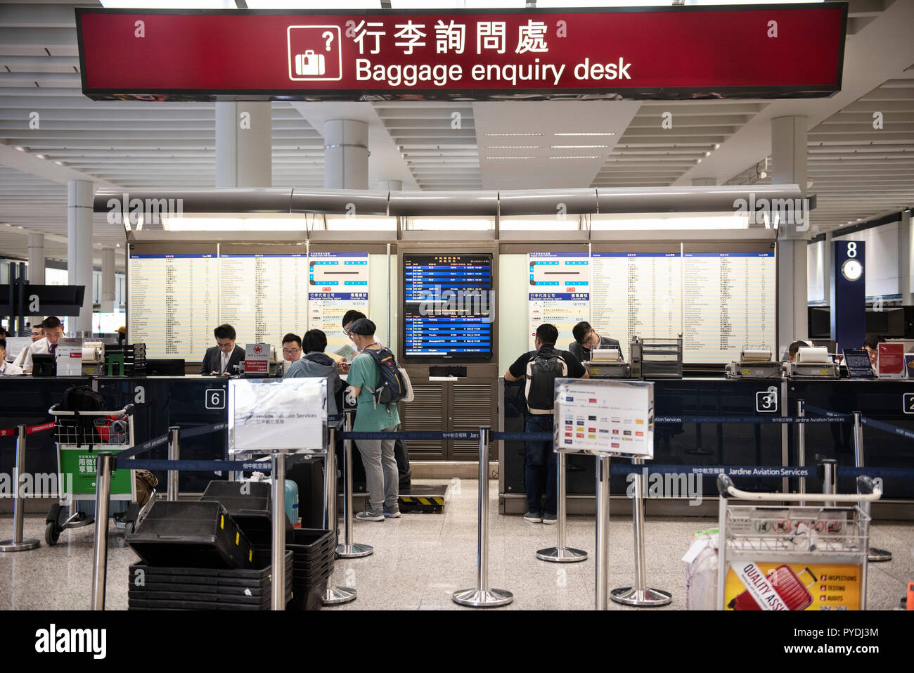Travellers are seen at the baggage enquiry desk in Hong Kong international airport Stock Photo