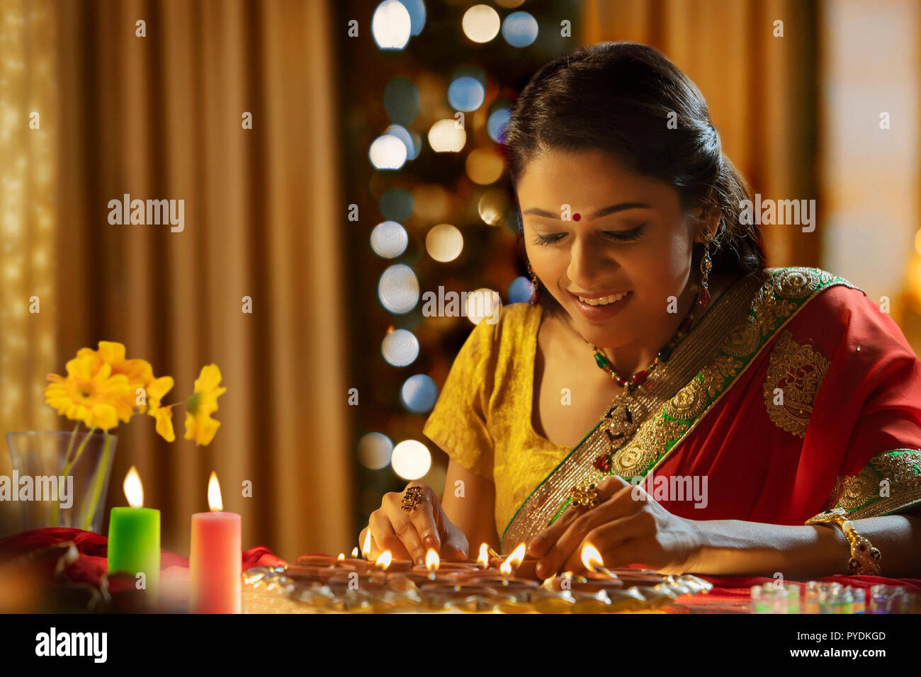Woman decorating the house with diya on the occasion of diwali Stock Photo