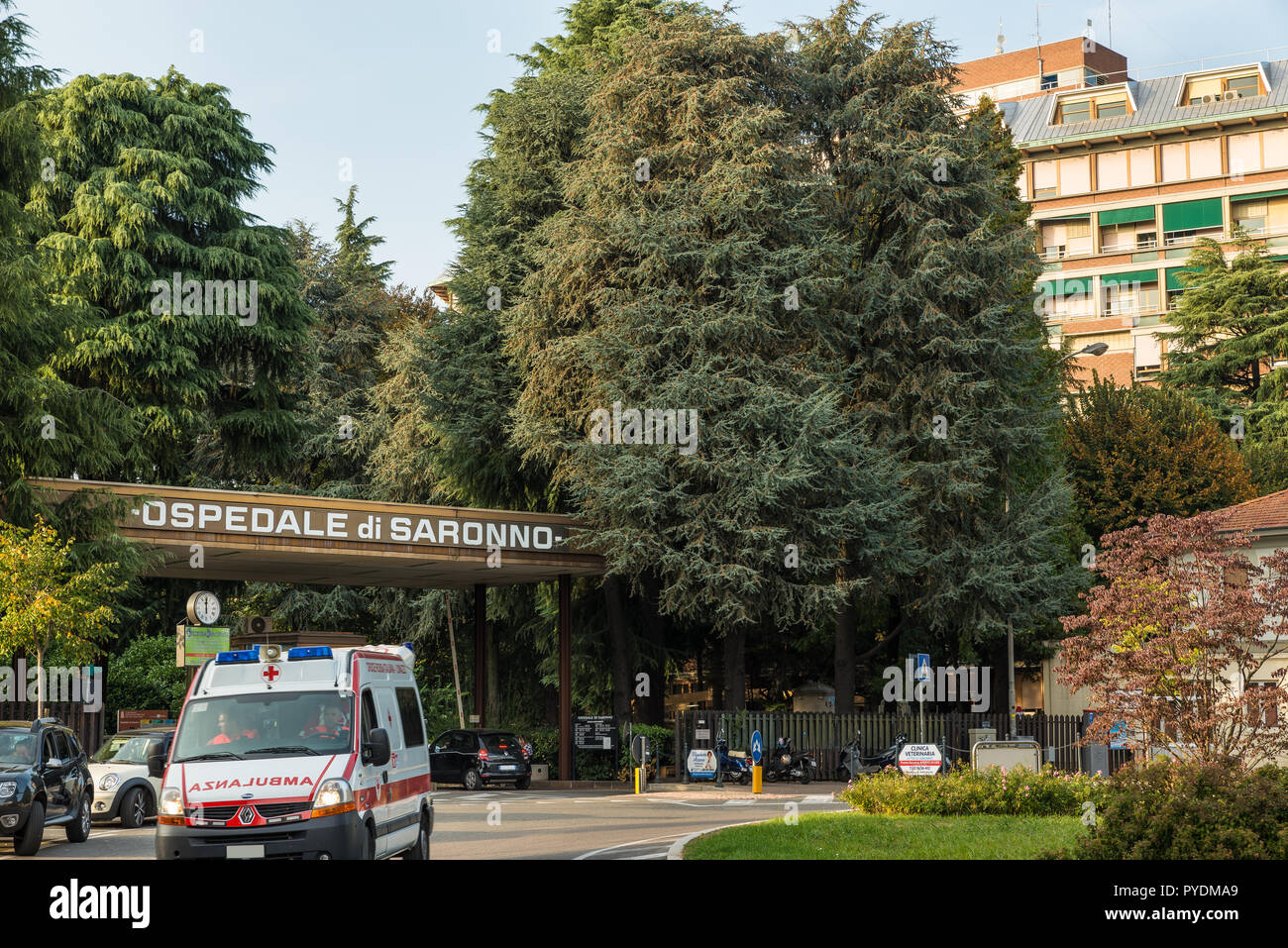 Saronno, Italy.  Entrance to the hospital with outgoing ambulance Stock Photo