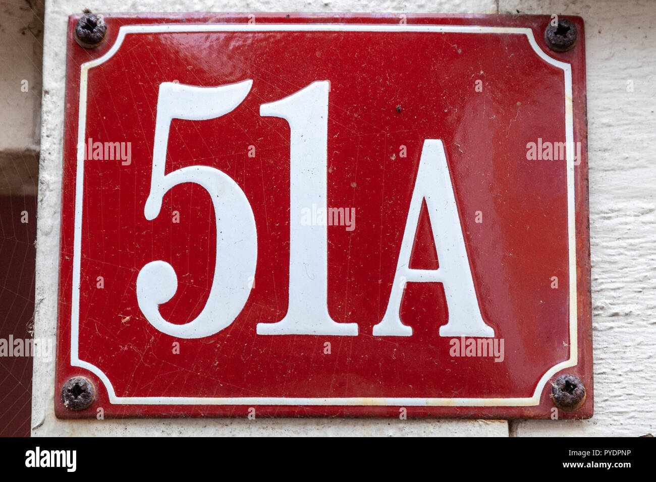 House number fifty-one A 51A on enamel plaque in white on red background from Sweden Stock Photo