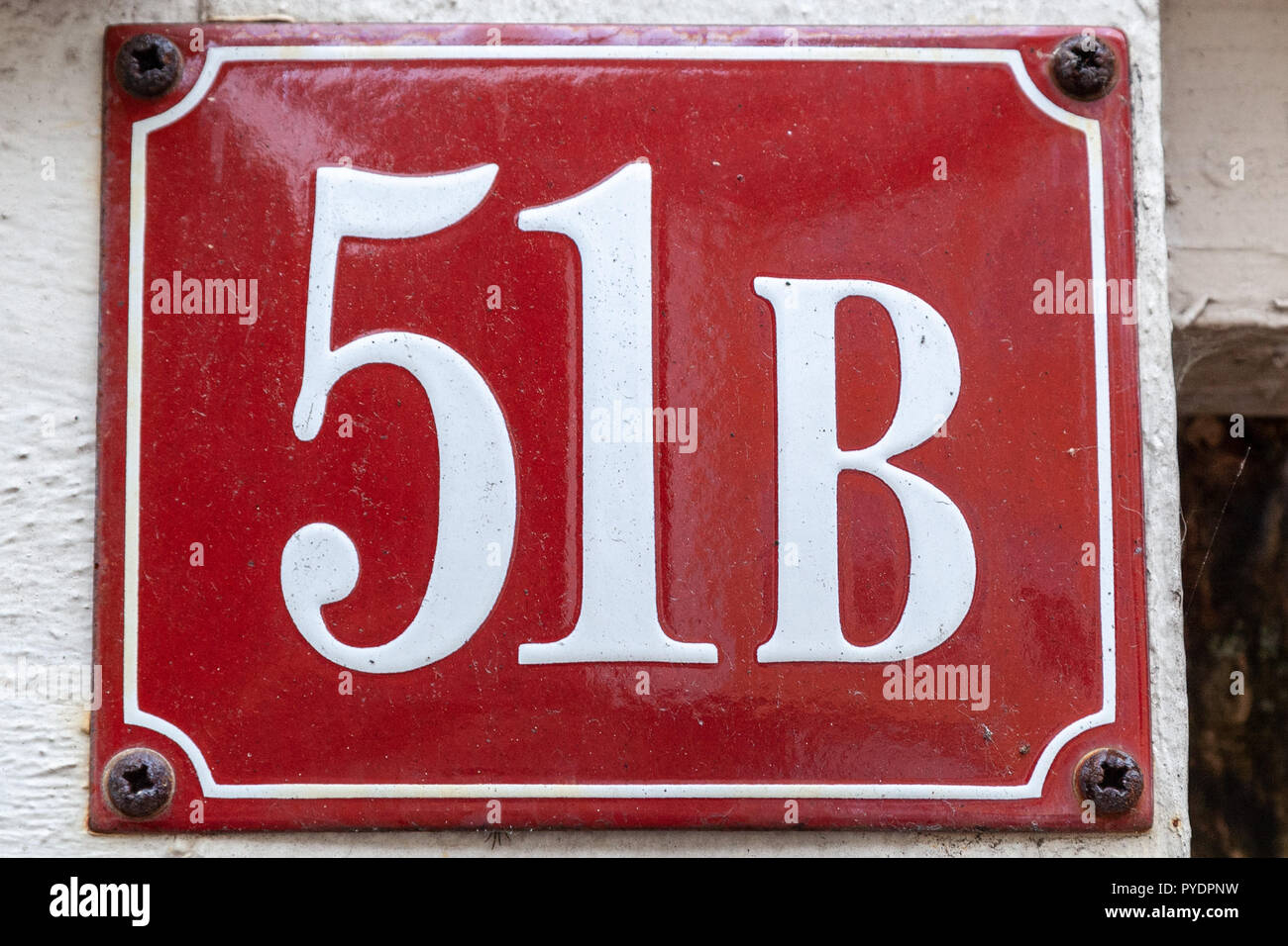 House number fifty-one B 51B on enamel plaque in white on red background from Sweden Stock Photo