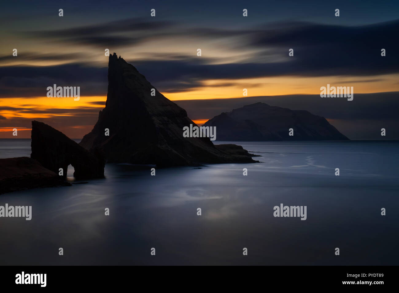 Drangarnir rocky arch on Vagar, Tindholmur and Mykines islands in dusk