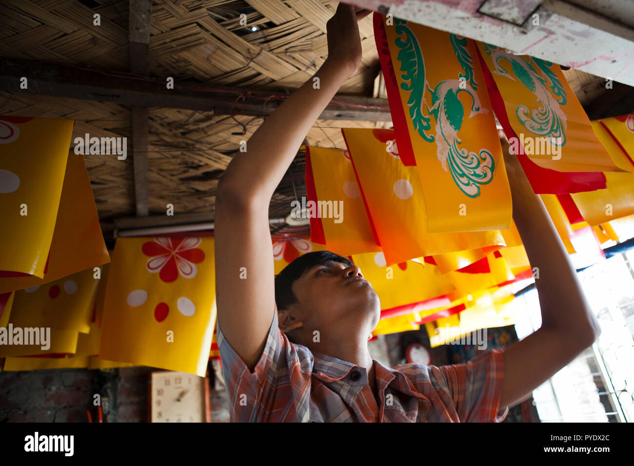 Joy, son of Proshanto Kumar Das and grandson of Raj Kumar Das, best known as RK Das, one of the first generation rickshaw artists in Bangladesh, is bu Stock Photo