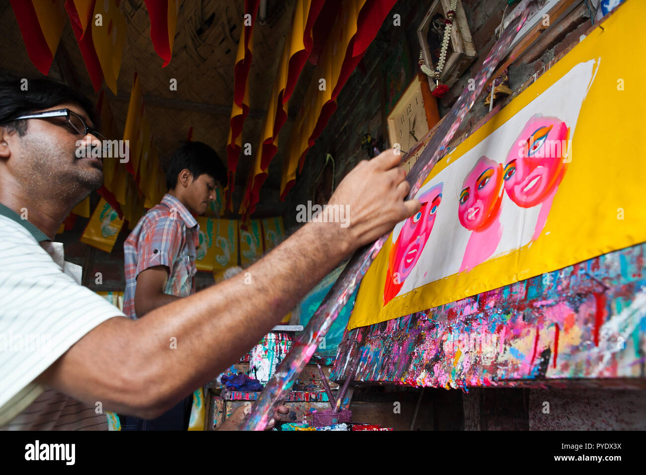 Proshanto Kumar Das, son of Raj Kumar Das, best known as RK Das, one of the first generation rickshaw artists in Bangladesh, is engaged in painting a  Stock Photo