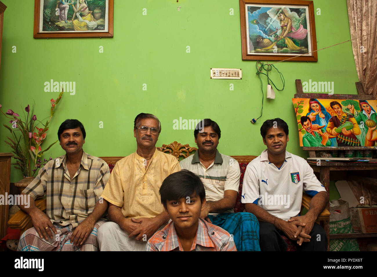 Raju Kumar Das, best known as RK Das, one of the first generation rickshaw artists in Bangladesh, poses to be photographerd along with his sons and gr Stock Photo