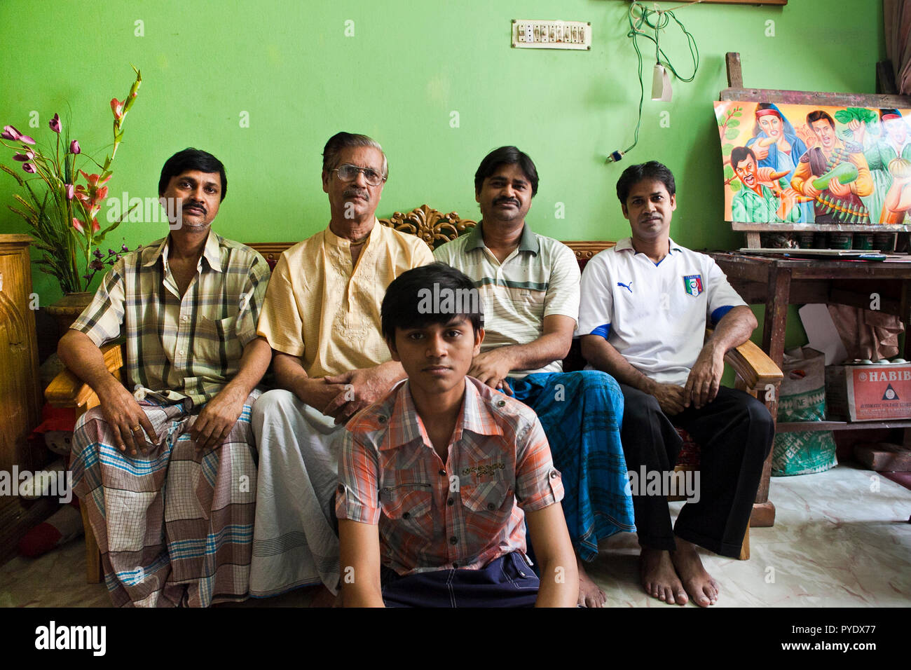 Raju Kumar Das, best known as RK Das, one of the first generation rickshaw artists in Bangladesh, poses to be photographerd along with his sons and gr Stock Photo