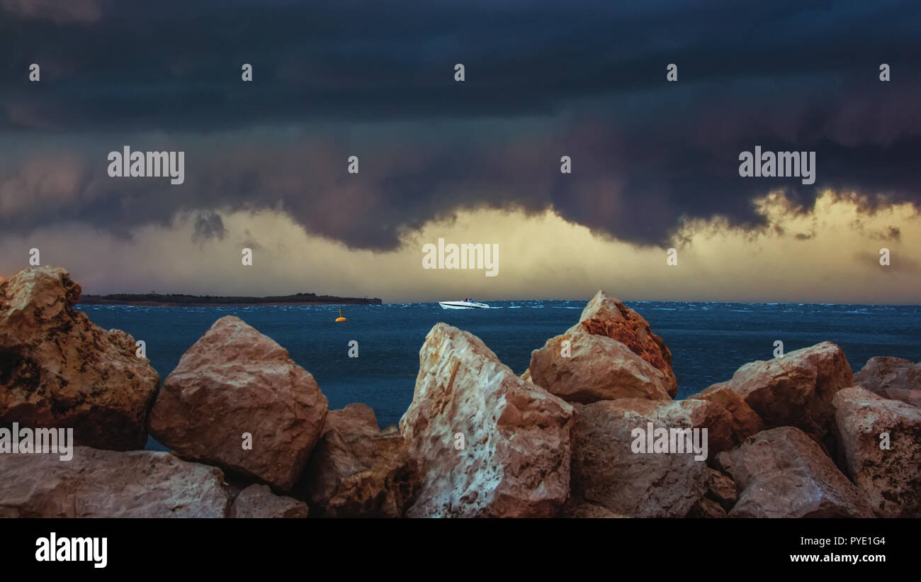 Dark big clouds and thunderstorm passing over the coastline, with heavy ...