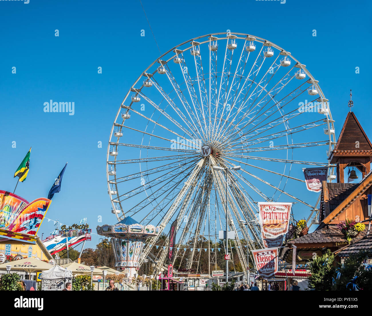 Honnover, Lower Saxony, Germany, October 13., 2018: View of the Ferris wheel at the Oktoberfest with various stalls and games stalls in the foreground Stock Photo