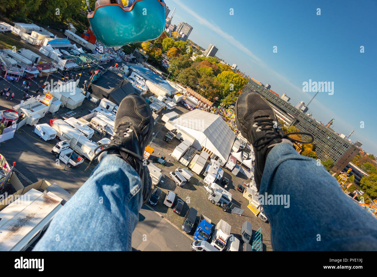 Honnover, Lower Saxony, Germany, October 13., 2018: View from the gondola of a chain catrussel with legs and feet of the passenger over the caravan an Stock Photo