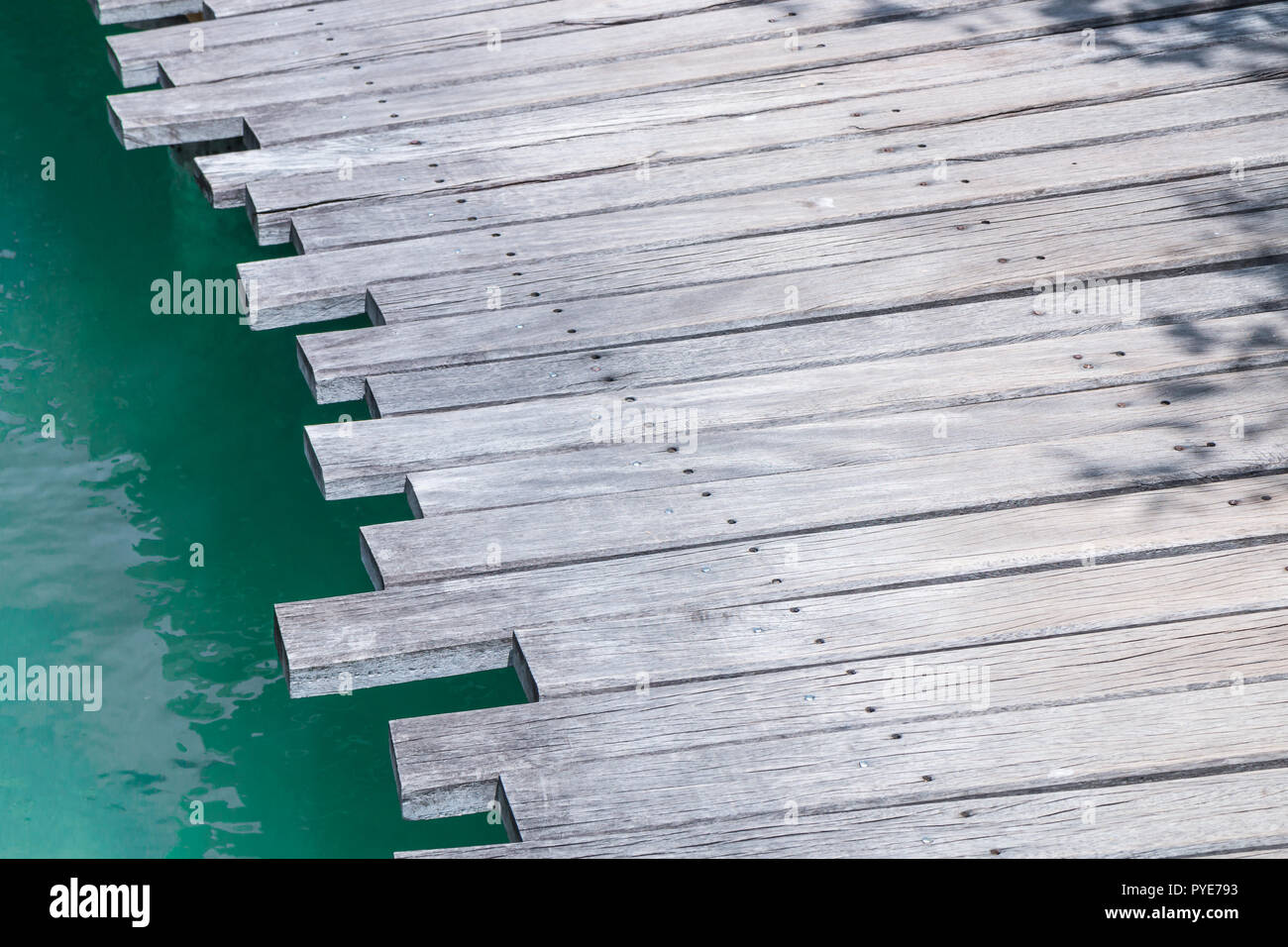 Closeup of a wooden bridge over the sea Stock Photo