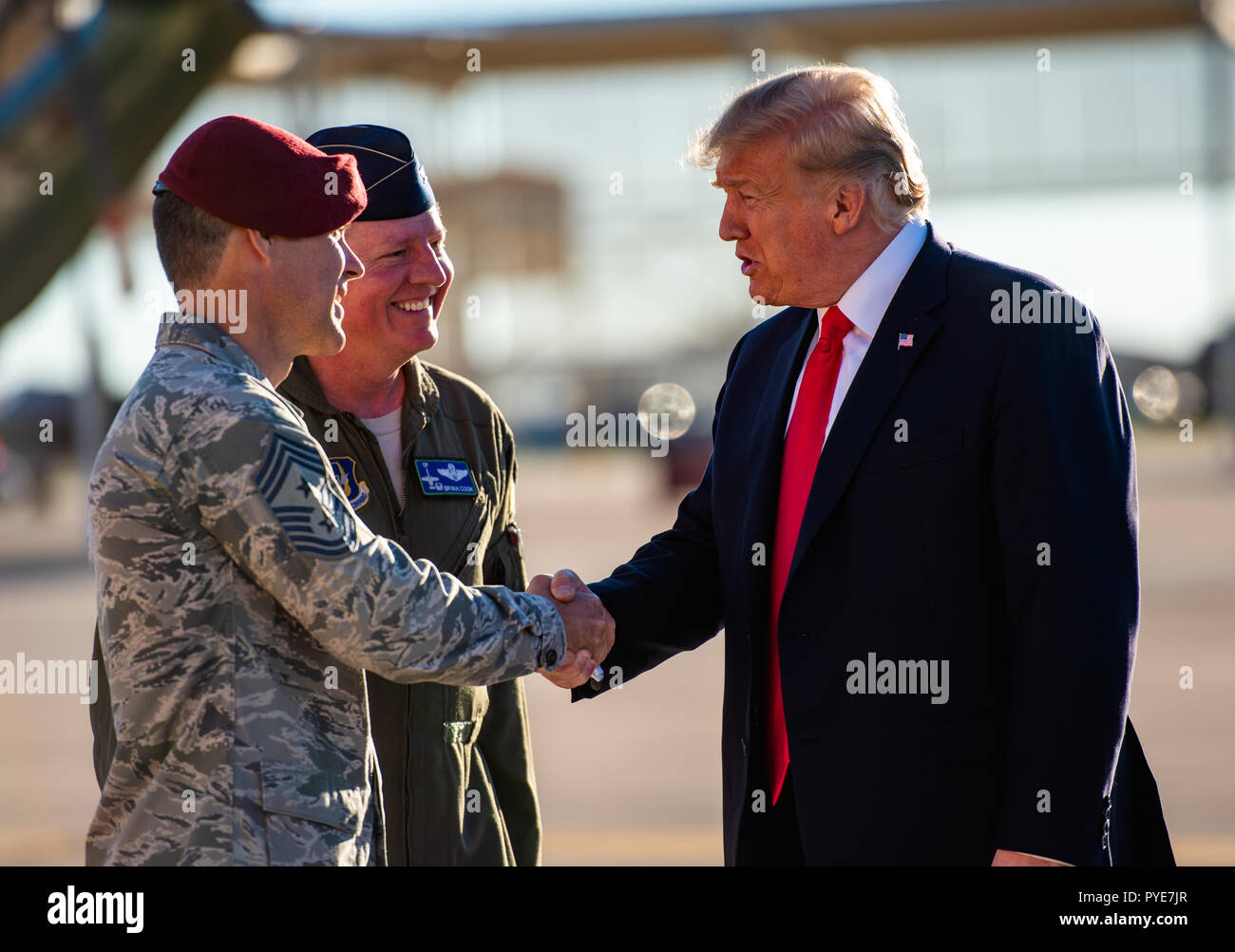 President Donald. J. Trump is greeted by Chief Master Sgt. Ronald Thompson, 56th Fighter Wing command chief, upon arrival to Luke Air Force Base, Ariz., Oct. 19, 2018.  Trump along with defense industry leaders visited Luke AFB to discuss current defense issues and to better understand Luke’s fighter training mission. (U.S. Air Force photo by Senior Airman Alexander Cook) Stock Photo