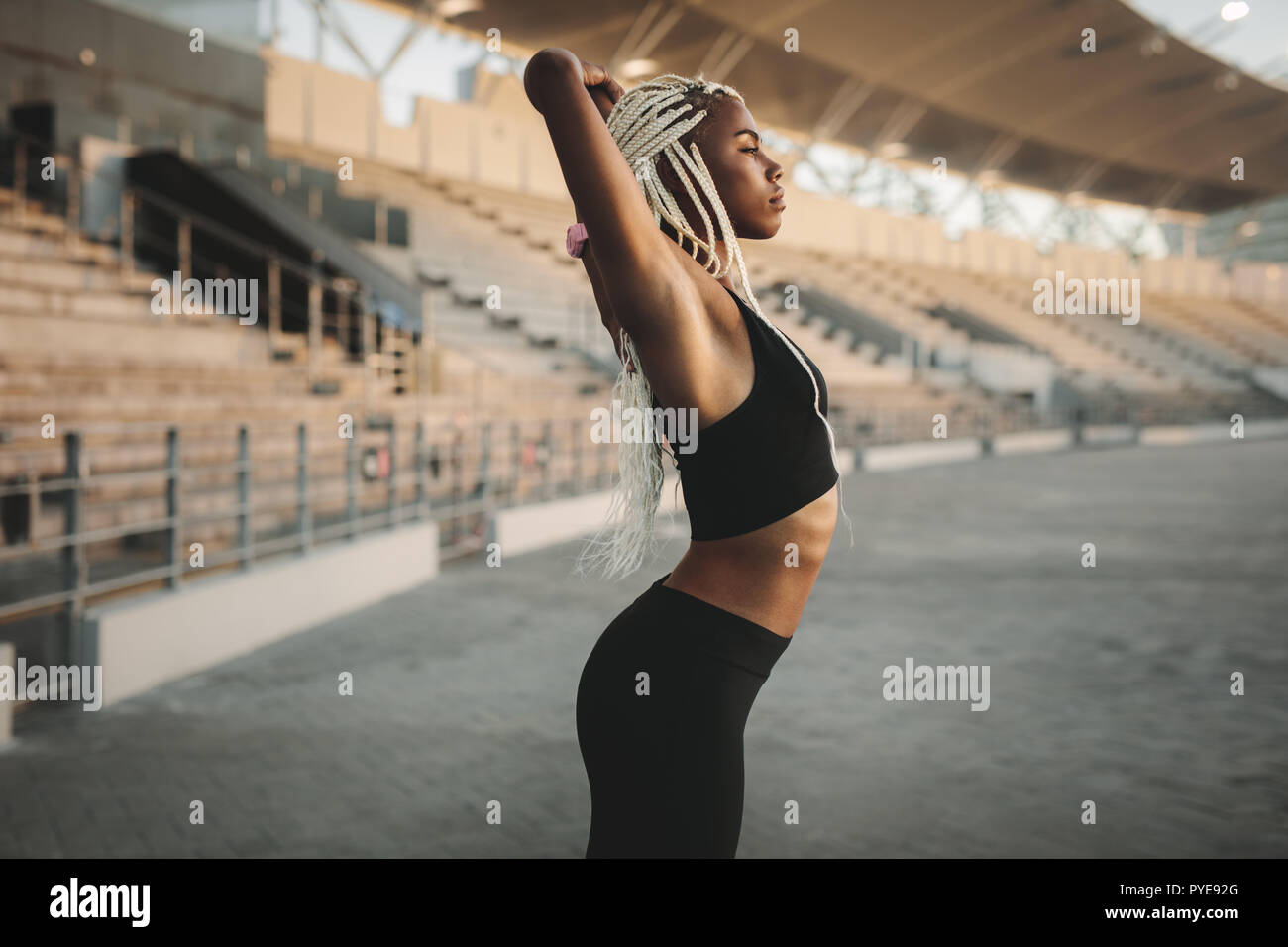 Young athletic woman in sports attire performing yoga under spot light  Stock Photo - Alamy