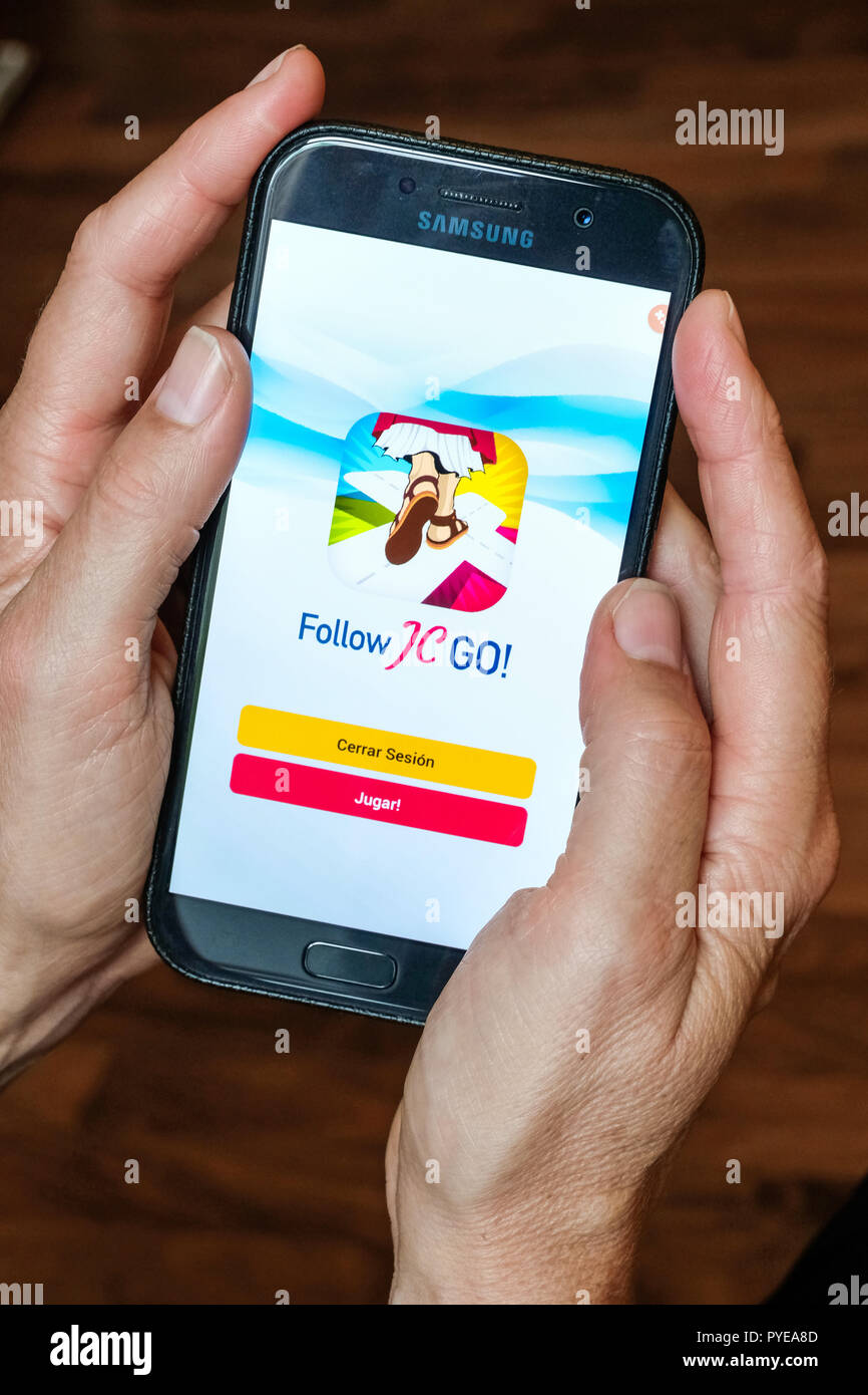 Vatican releases the smartphone app 'Follow JC GO!' (Follow Jesus Christ), which is almost identical to the model Pokémon Go. Instead of monsters, saints are now being sought and catched in the Vatican game. The game is currently only available in Spanish, other language versions will be released shortly. Photo shows login page of 'Follow JC GO!' on a smartphone. Stock Photo