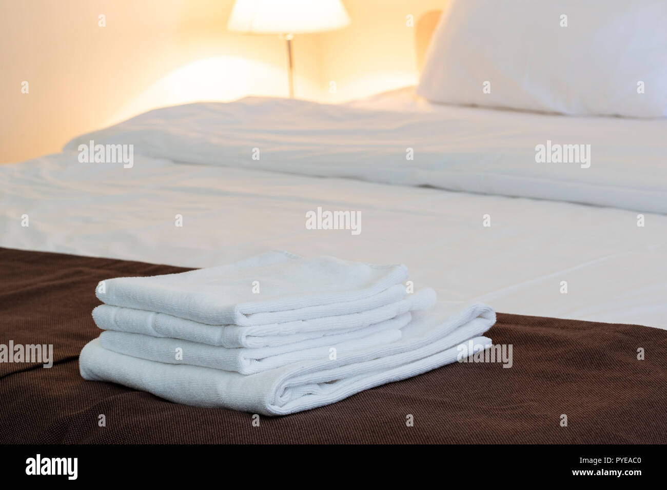 White Fluffy Towels On Bed For Hotel Customer Stock Photo - Download Image  Now - Arrangement, Bed - Furniture, Bedroom - iStock