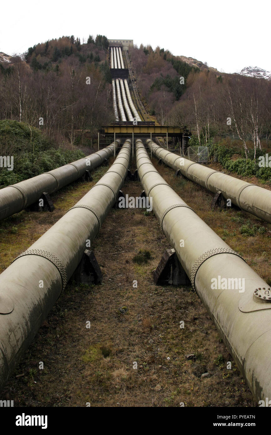 The four pipes that run down the mountain Ben Vorlich, and then takes the water from Loch Sloy, which is damned behind it, down to the hydro electric power station that sits on the banks of Loch Lomond in Scotland. Stock Photo