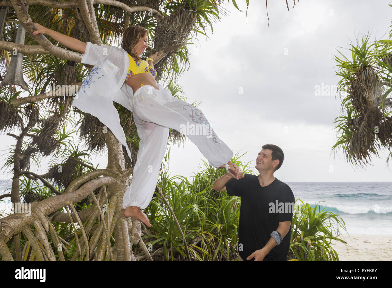 Happy young couple on a beautiful tropical beach. Honeymoon on an exotic island. Honeymoon beautiful couple on an exotic beach. Couple in love travel  Stock Photo