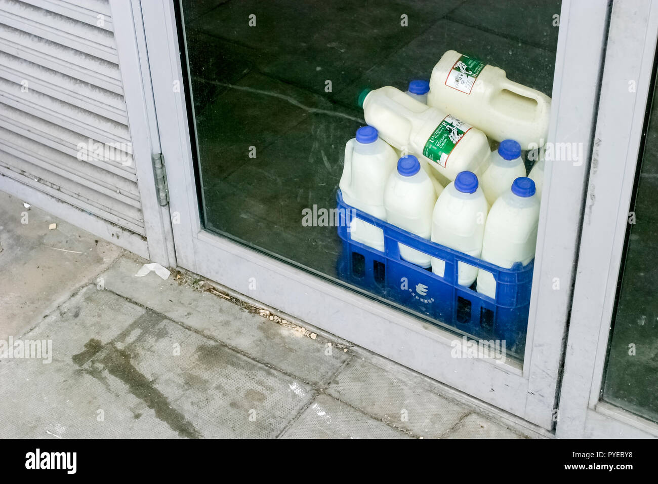 A Crate Of Plastic 2 Litre Milk Bottles Inside A Glass Shop Door England Uk Stock Photo Alamy