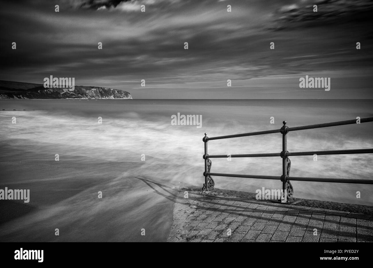 Misty water lapping at an access ramp to the sandy Swanage beach Stock Photo