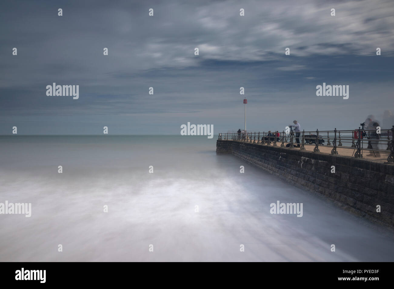 A colour photo of the pier at Swanage, Dorset using a slow shutter speed to blur the movement of the sea Stock Photo