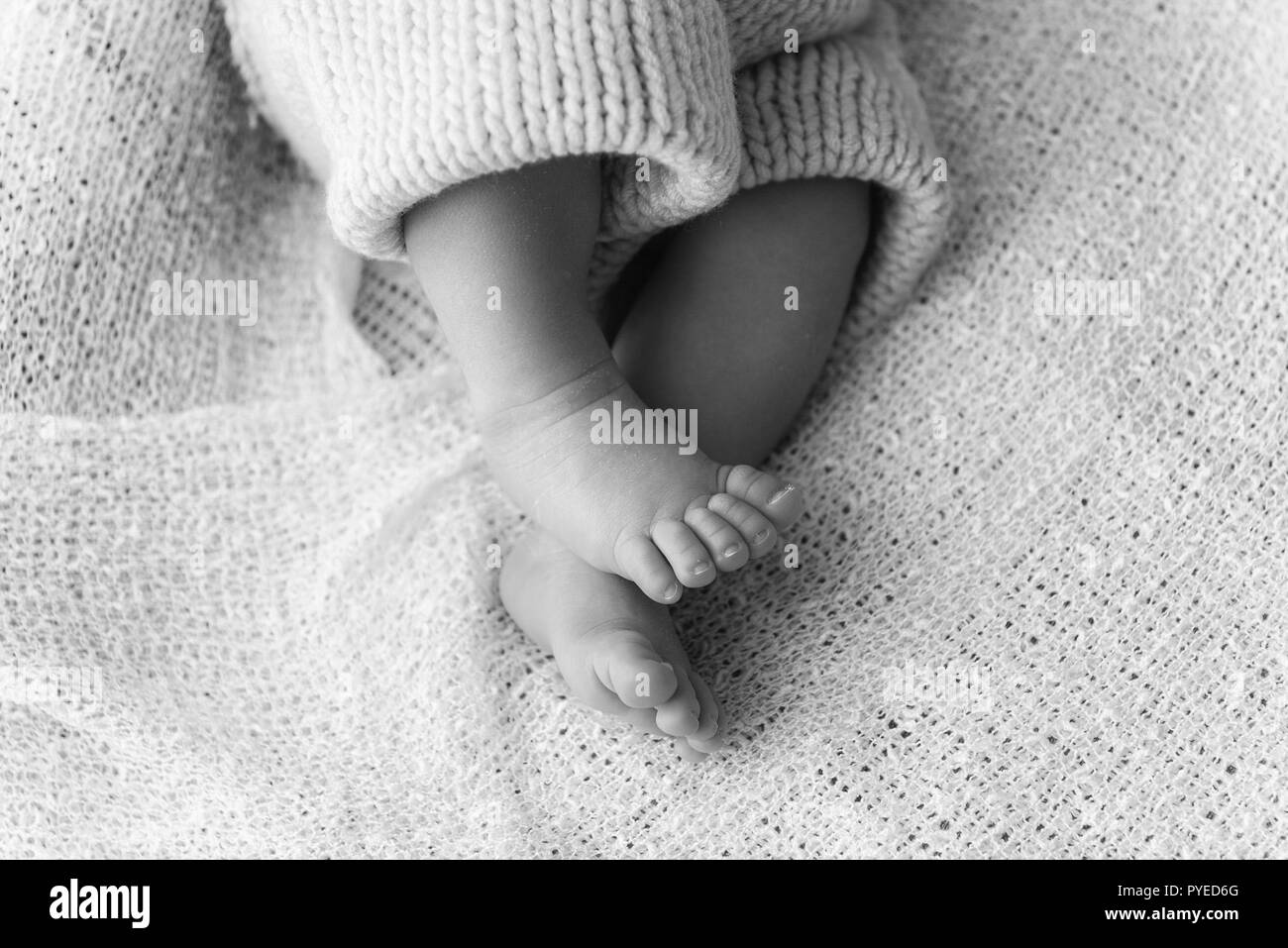 Closeup of a newborn baby feet with beautiful selective focus concept for maternity and tenderness