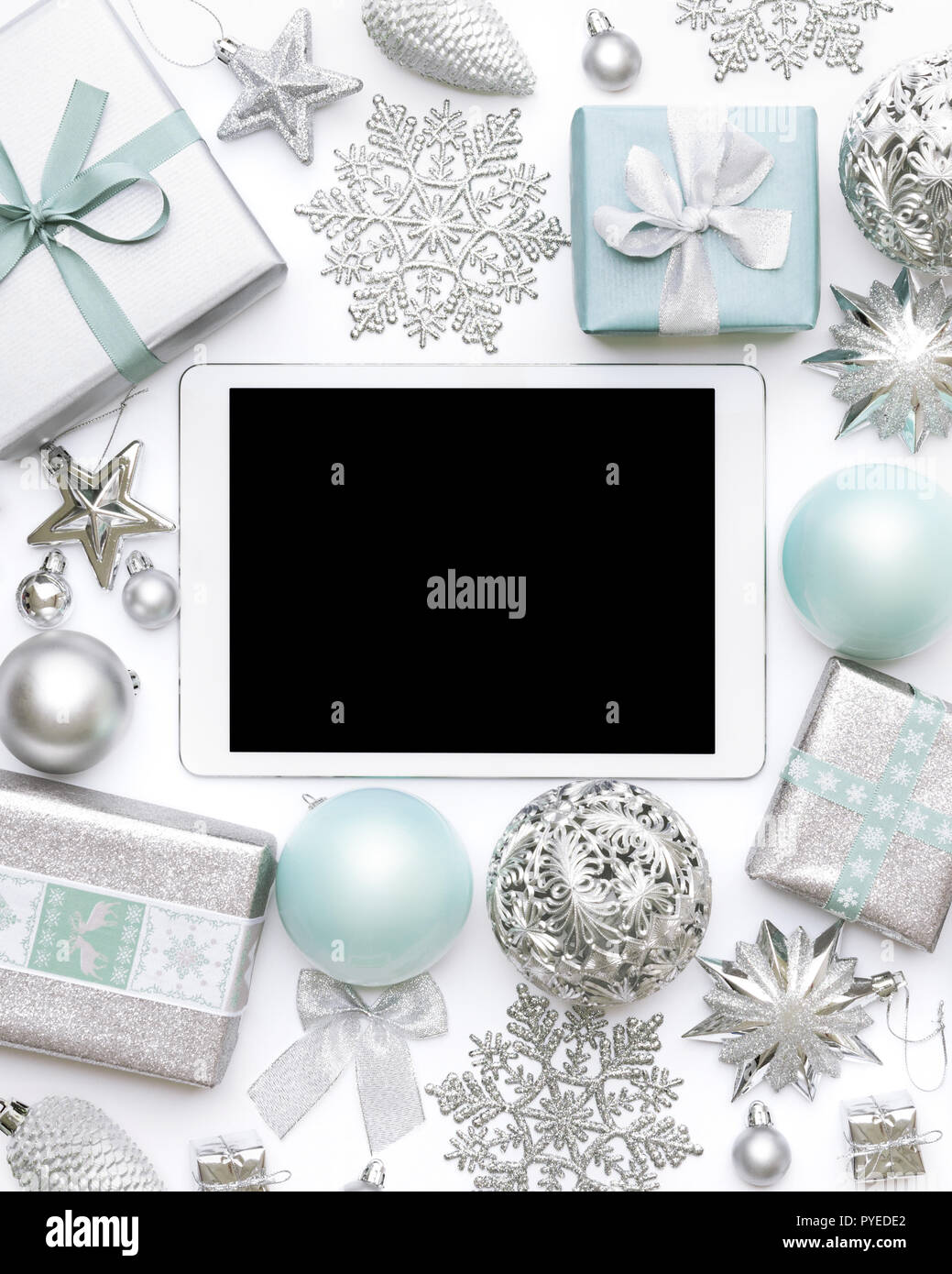 Online Christmas Shopping. Boxing Day Sale Background. Wrapped christmas presents, ornaments and blank screen digital tablet isolated over white backg Stock Photo