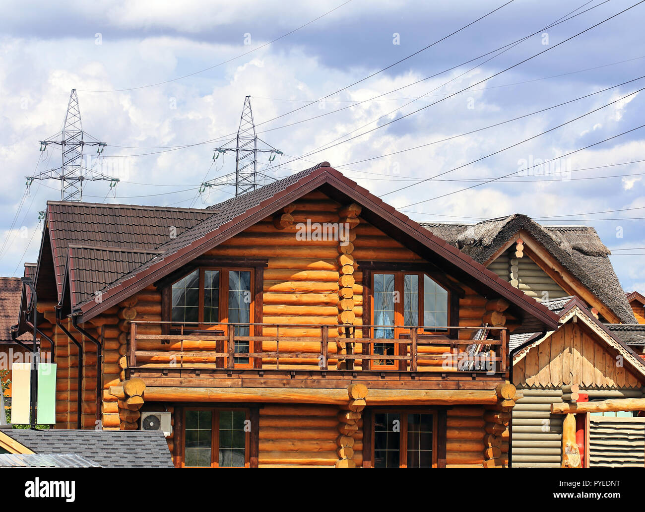 Wooden cottage of the brown color with balcony Stock Photo - Alamy