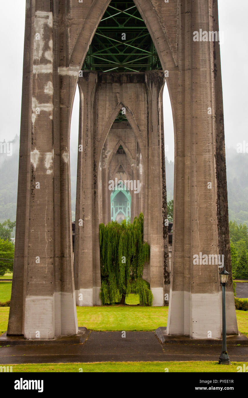View southwest underneath the St. Johns Bridge and across Cathedral Park in Portland, Oregon, United States Stock Photo