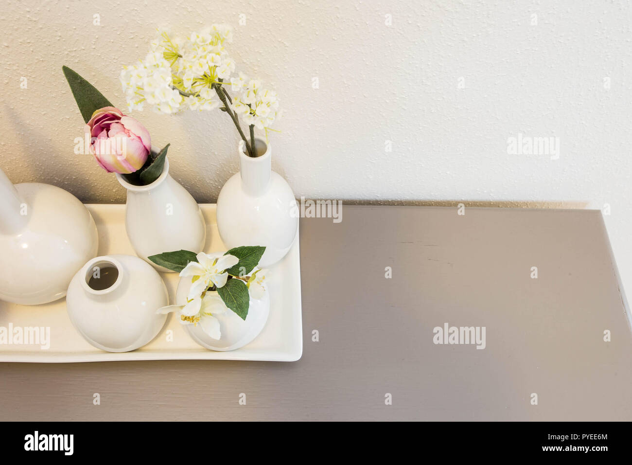 different pink flowers in vases on white background Stock Photo - Alamy