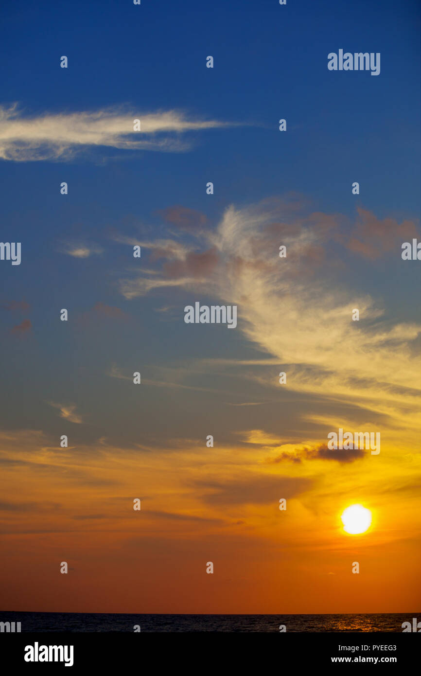 Sunset over ocean with dramatic clouds Stock Photo - Alamy