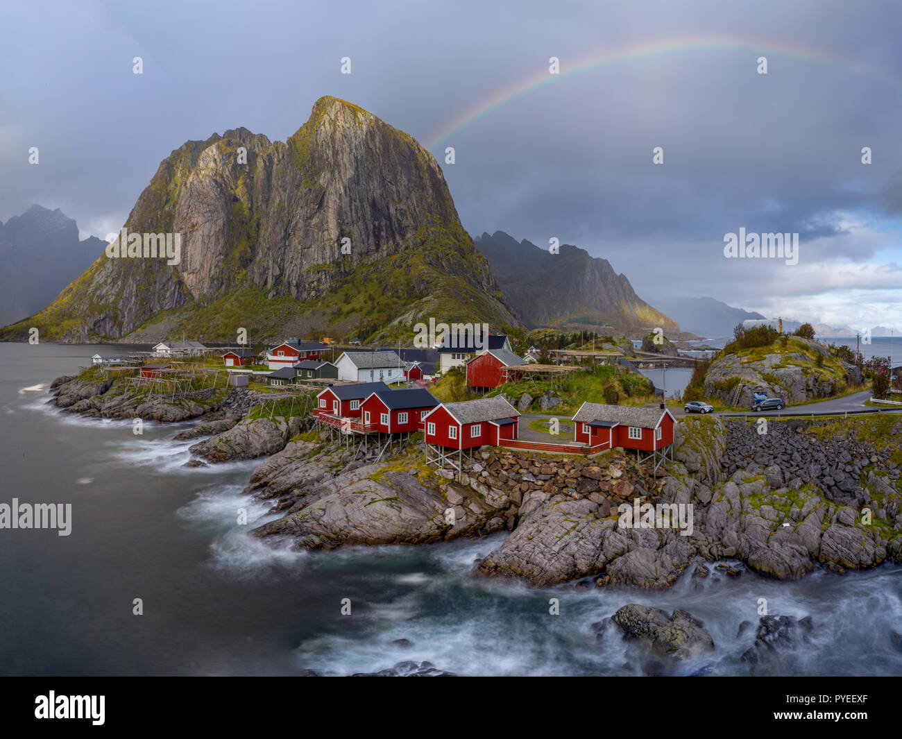 Rainbow over Hamnoy fishing village nestled into Norwegian fjords - Lofoten Stock Photo