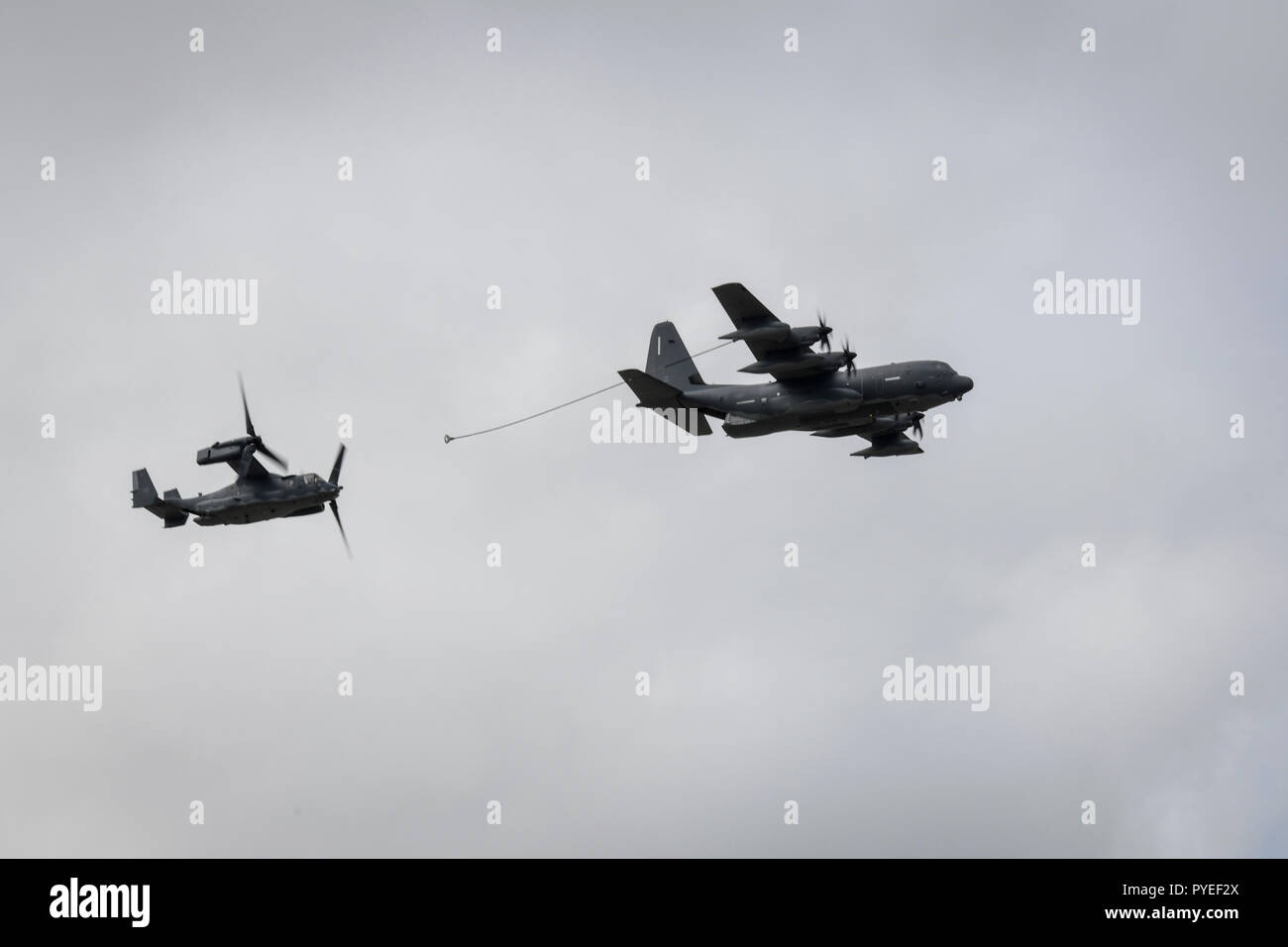 An MC-130J Commando II, assigned to the 15th Special Operations Squadron, and a CV-22 tiltrotor aircraft, assigned to the 8th Special Operations Squadron, demonstrate mid-flight refueling during an aerial demonstration at the U.S. Air Force Master Sgt. John A. Chapman Medal of Honor celebration at Hurlburt Field, Florida, Oct. 26, 2018. Hurlburt Field hosted several festivities such as an aerial demonstration, a building renaming and a live concert in memory of Chapman, a combat controller who made the ultimate sacrifice during an intense battle in the mountains of Afghanistan. Chapman was pos Stock Photo