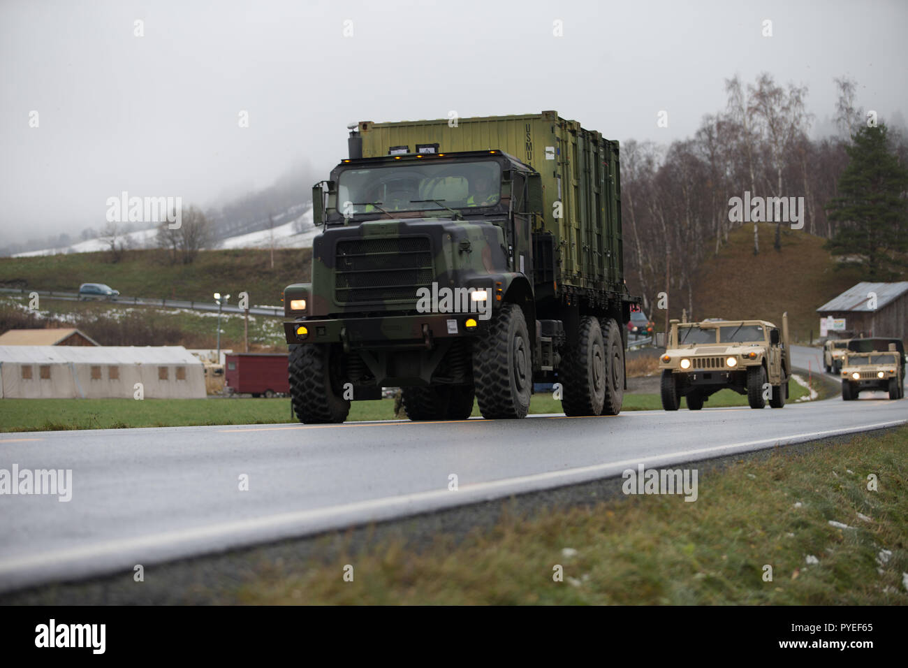 U.S. Marines with Combat Logistics Battalion 2, 2nd Marine Logistics Group-Forward, leave for a route reconnaissance convoy in Voll, Norway, Oct. 26, 2018. The Marines checked the road conditions and tested communications equipment during Exercise Trident Juncture 18. The exercise enhances the U.S. and NATO Allies’ and partners’ abilities to work together collectively to conduct military operations under challenging conditions. (U.S. Marine Corps photo by Sgt. Bethanie C. Sahms) Stock Photo