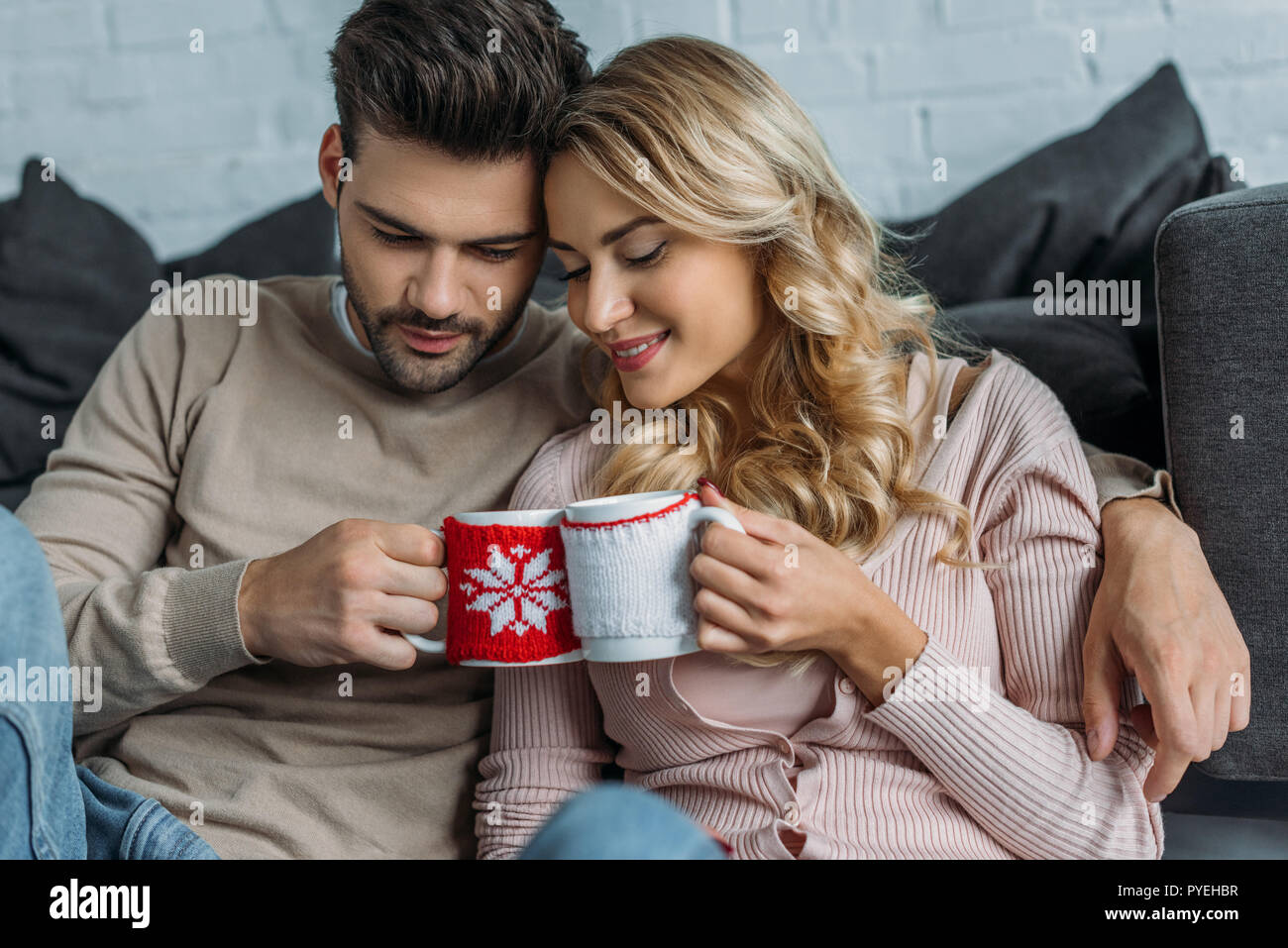 couple clinking with cups of cappuccino at home, christmas concept ...