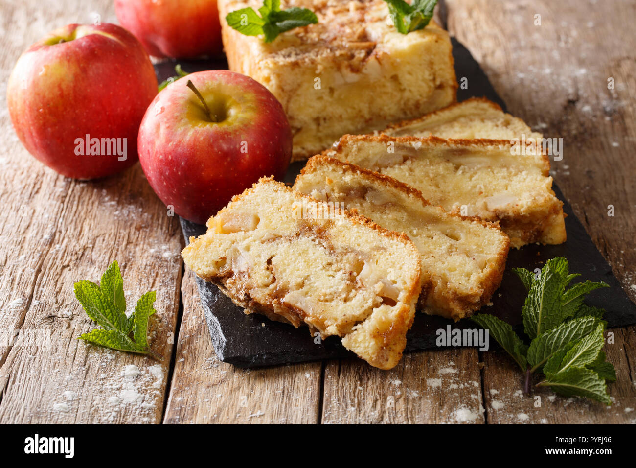 Baked sweet apple bread pie with cinnamon and mint close-up on the table. horizontal Stock Photo
