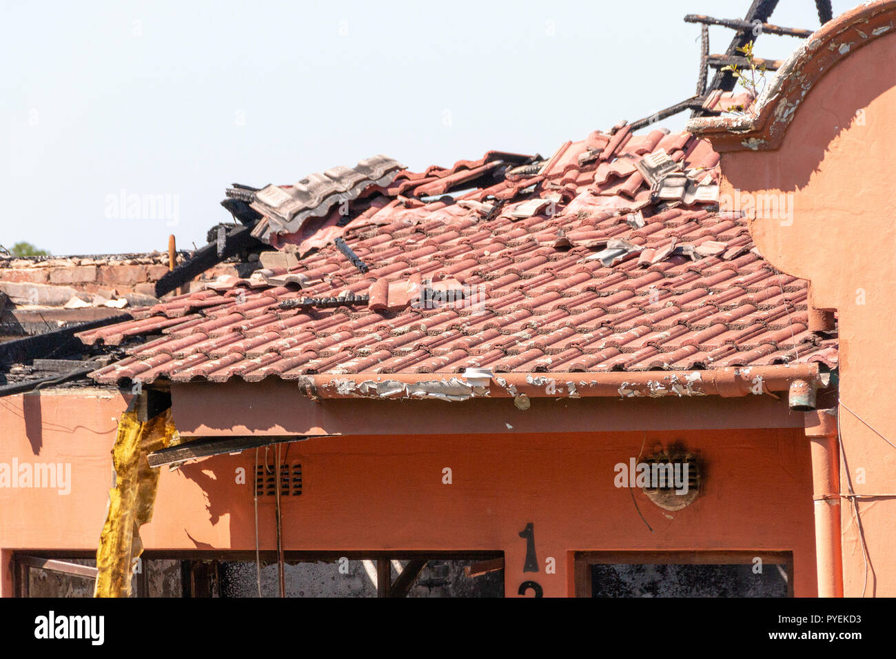 A close up view of a front section of  the burned out shell of a house that caught on fire and was totally destroyed Stock Photo