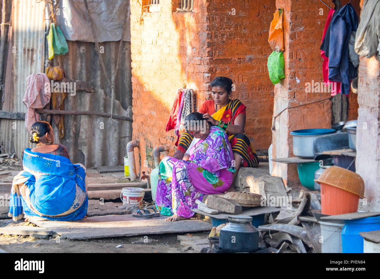 Indian women in saris grooming each other in rural  India Stock Photo