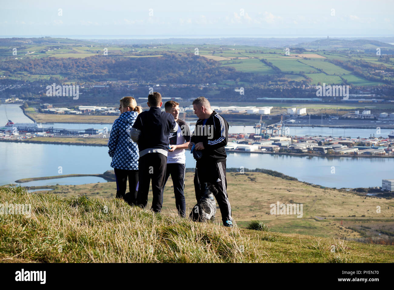 tourists and dog walkers out on mcarts fort at the top of Cave Hill overlooking belfast on a