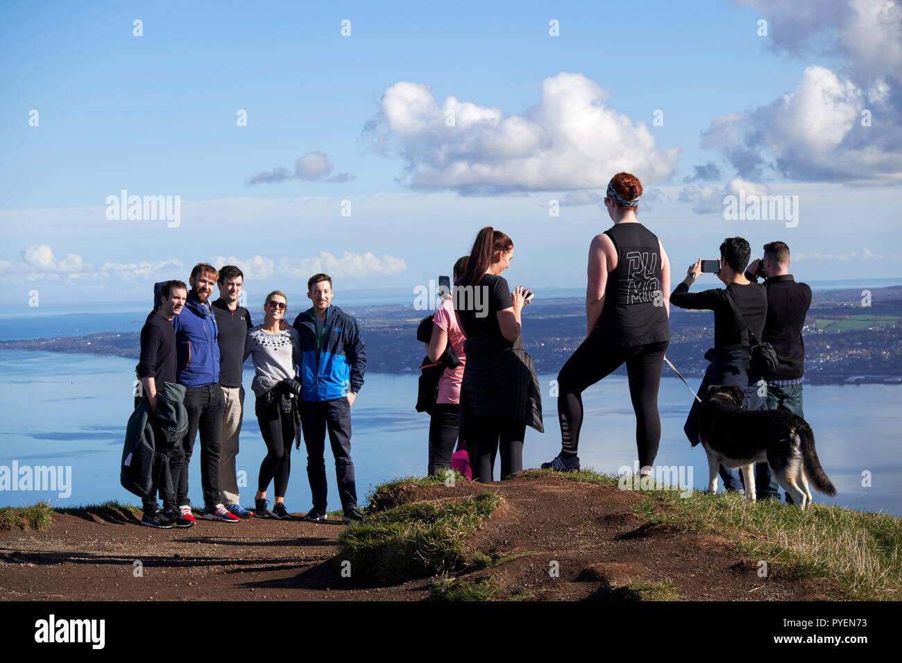 tourists and dog walkers out on mcarts fort at the top of Cave Hill overlooking belfast on a