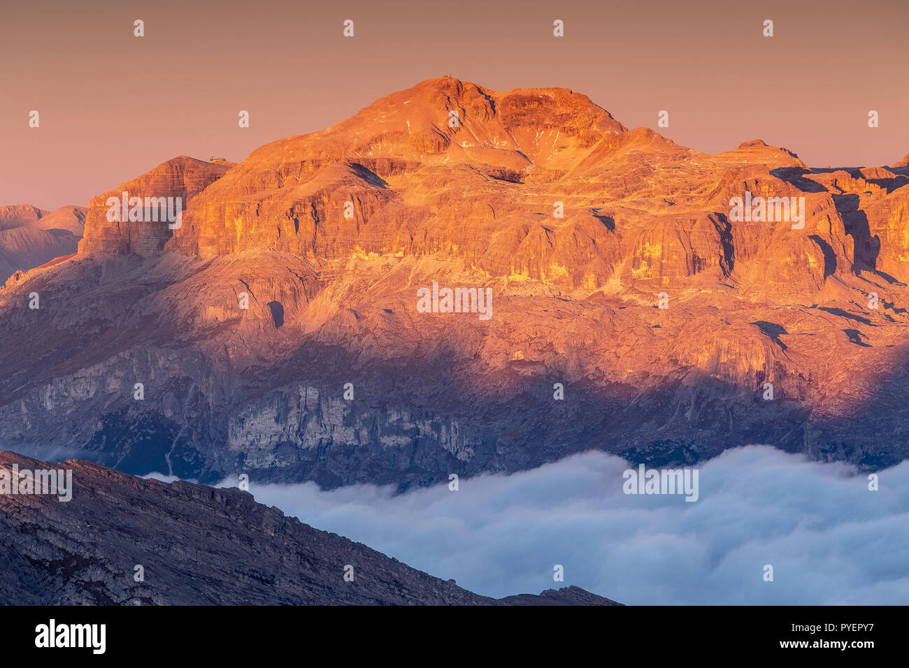 Alpenglow on the Sella mountain group and Piz Boè peak. Sunlight at sunrise. The Dolomites. Italian Alps. Europe. Stock Photo