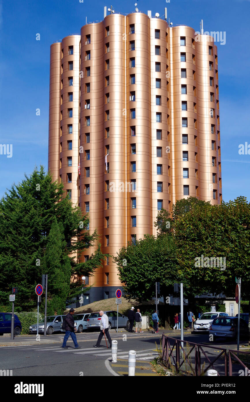 An eye-catching 16-storey residential building with curved frontages and bronze-coloured cladding in Noisiel, a south eastern suburb of Paris France Stock Photo