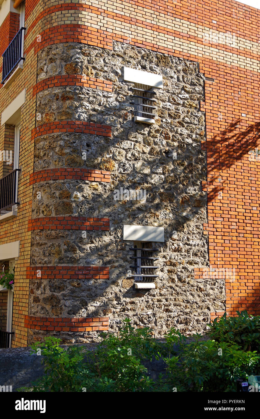 Paris, France, details of late 19thC apartment building finished in yellow & red brickwork, rough-cast stone, with elegant wrought iron balconies Stock Photo