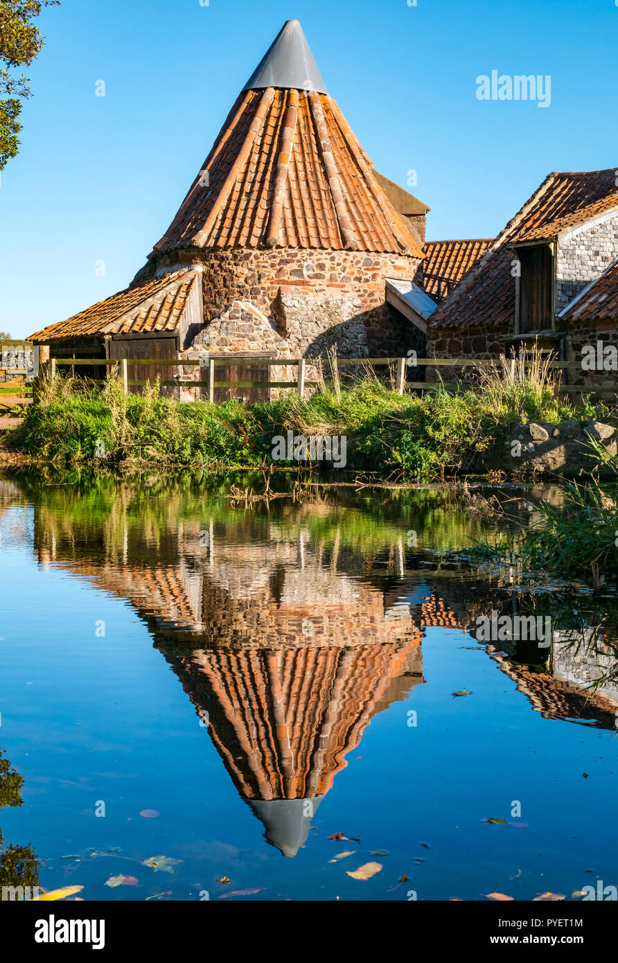Quirky 18th century watermill, Preston Mill, with reflection in mill