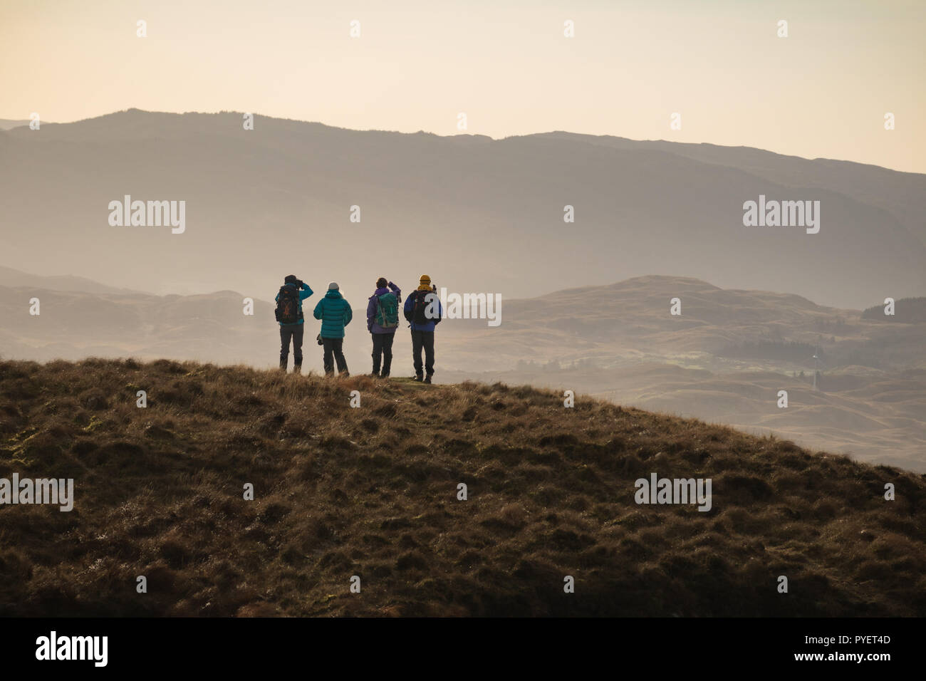 A group of walkers pause to enjoy a view Stock Photo